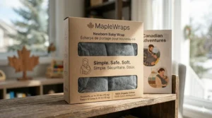 Eco-friendly packaging for a baby wrap for newborns featuring English and French (Porte-bébé) instructions for Canadian parents.