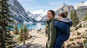 A toddler tucked into a carrier with a warm fleece cover, perfect for Canadian winters and snowy walks.