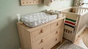 Dual-purpose nursery furniture for small room spaces featuring a compact dresser with a removable changing pad.