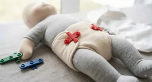 Colorful Snappi fasteners securing a prefold diaper snugly for a secure, pin-free fit.